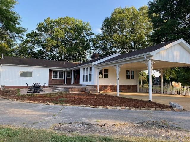 ranch-style home with a patio area and a carport