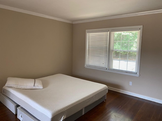 bedroom featuring dark hardwood / wood-style floors and ornamental molding