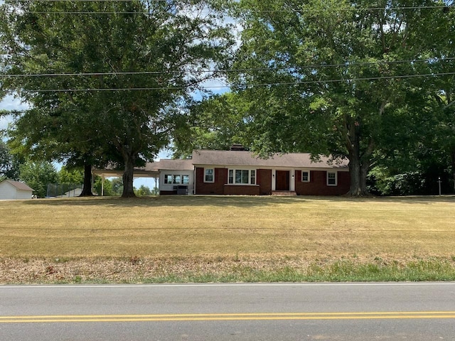 ranch-style home with a front lawn