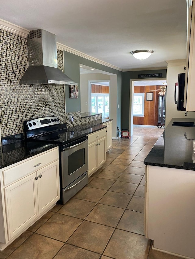 kitchen featuring electric range, sink, wall chimney range hood, dark tile patterned floors, and crown molding