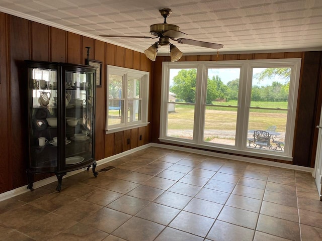 unfurnished sunroom with ceiling fan