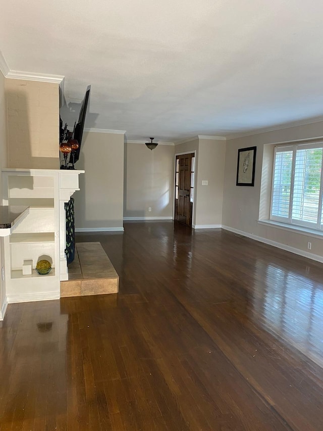 unfurnished living room featuring dark hardwood / wood-style flooring, crown molding, and a tile fireplace