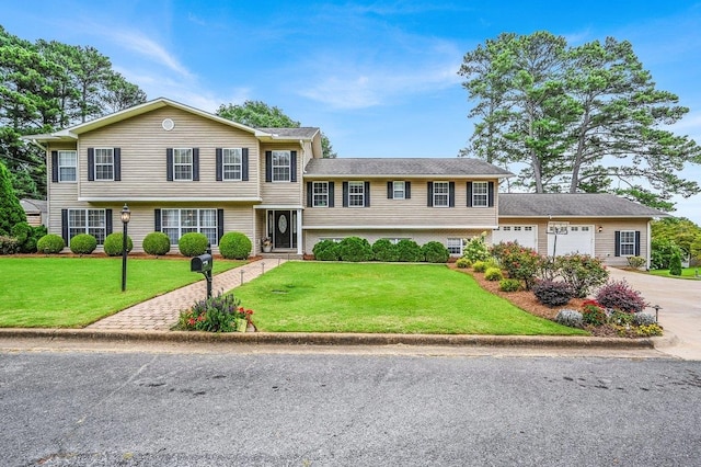 split level home featuring a front yard and a garage