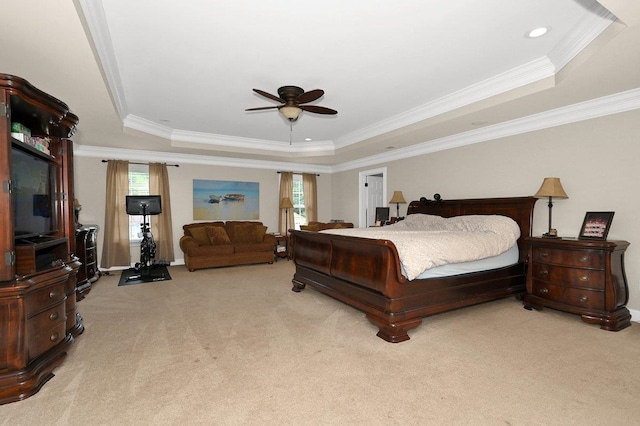 bedroom with a raised ceiling, ceiling fan, crown molding, and light colored carpet