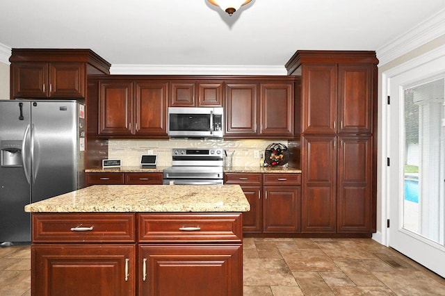 kitchen featuring decorative backsplash, a center island, stainless steel appliances, and crown molding