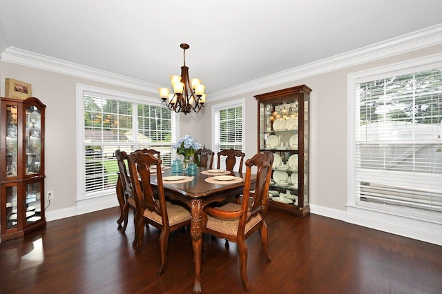 dining room with dark hardwood / wood-style flooring, crown molding, and a chandelier