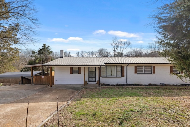 single story home featuring a carport and a front yard