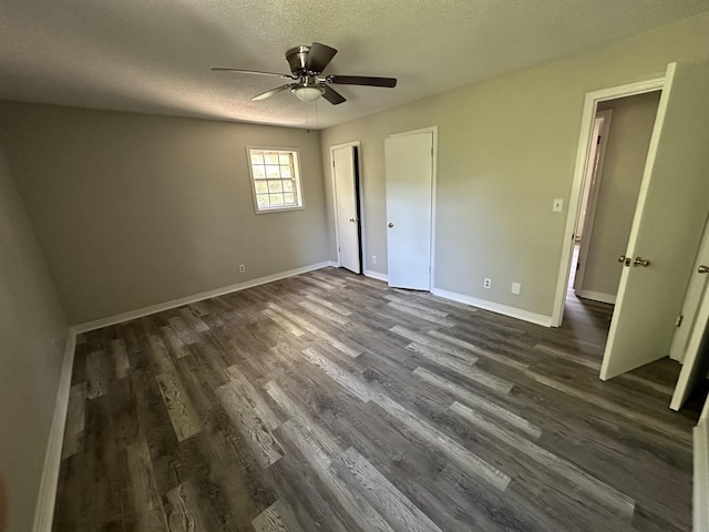 unfurnished bedroom featuring a textured ceiling, ceiling fan, and dark wood-type flooring