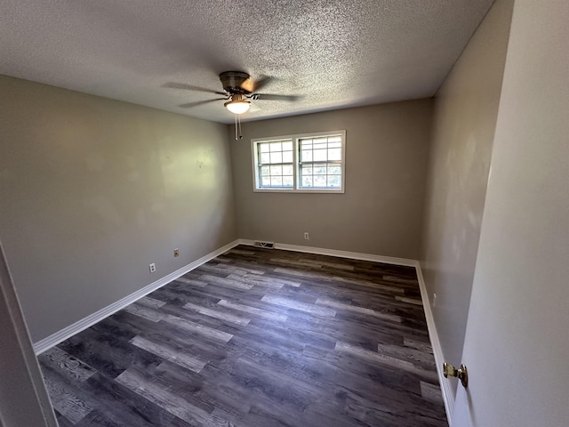 unfurnished room with dark hardwood / wood-style floors, ceiling fan, and a textured ceiling