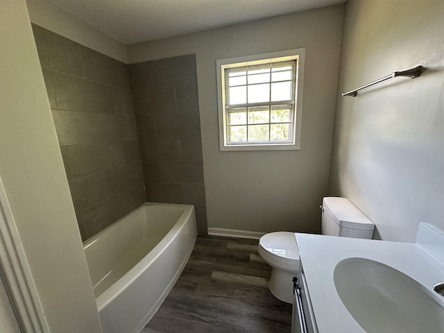 bathroom with hardwood / wood-style flooring, vanity, and toilet