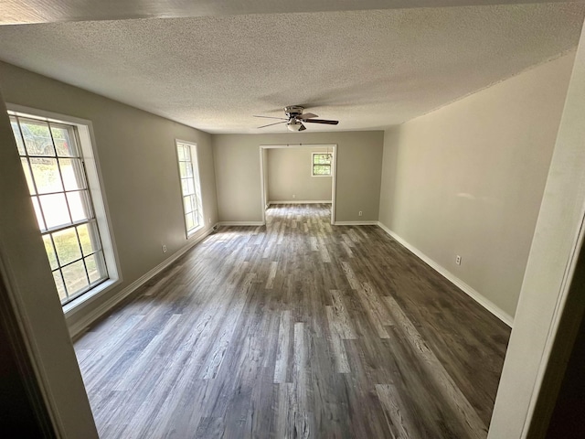 spare room featuring a textured ceiling, ceiling fan, and dark hardwood / wood-style floors