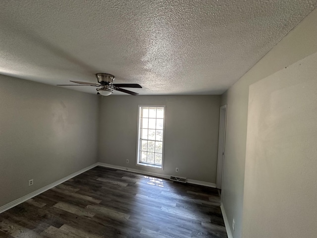 spare room with a textured ceiling, dark hardwood / wood-style floors, and ceiling fan