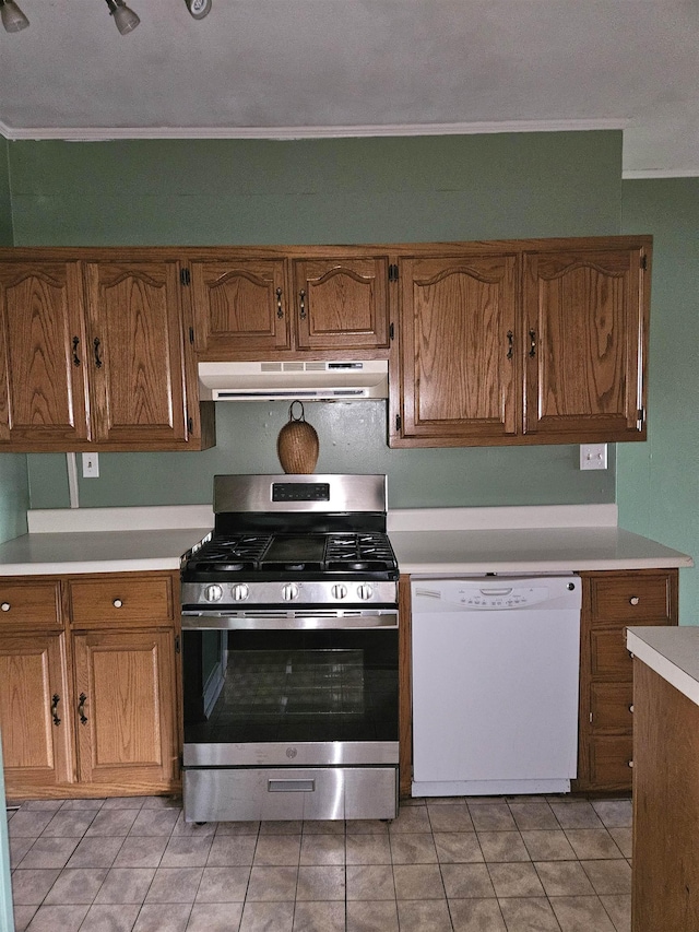 kitchen with white dishwasher, gas stove, and light tile patterned floors