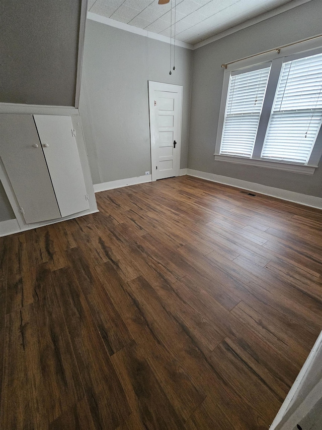 interior space featuring dark hardwood / wood-style floors, ceiling fan, and ornamental molding