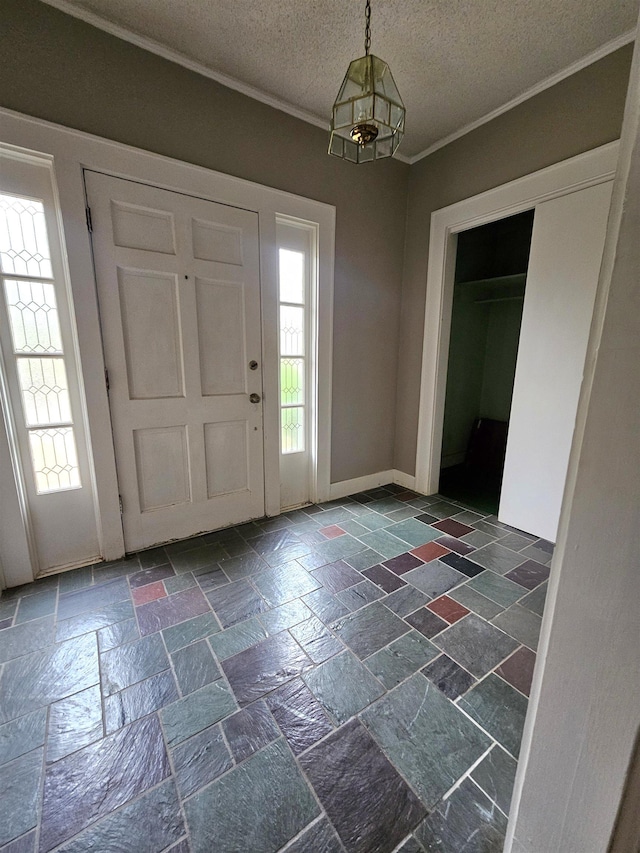 foyer entrance with a textured ceiling and ornamental molding