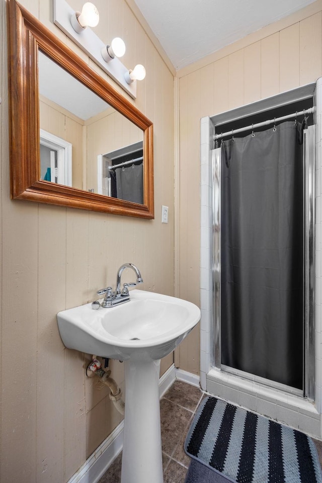 bathroom featuring a shower with curtain and wood walls