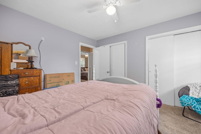 carpeted bedroom with multiple closets and ceiling fan