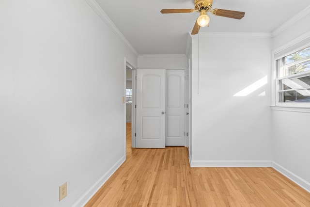 interior space with light hardwood / wood-style flooring, ceiling fan, and ornamental molding