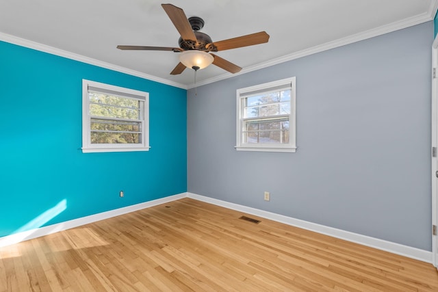 empty room with ceiling fan, light hardwood / wood-style floors, and ornamental molding