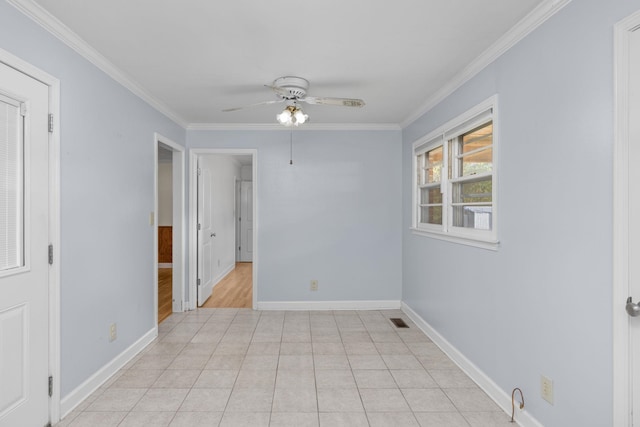 tiled empty room featuring ceiling fan and ornamental molding