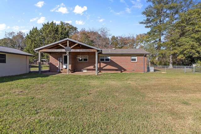 rear view of property featuring a lawn