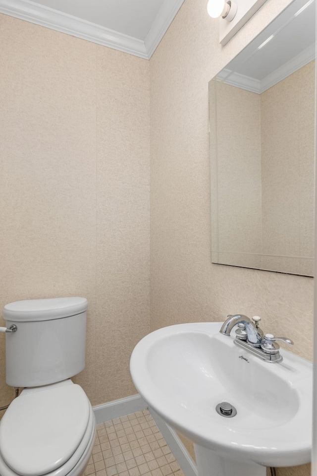 bathroom with tile patterned floors, toilet, sink, and ornamental molding