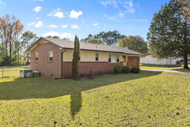 view of home's exterior featuring a lawn and central AC unit