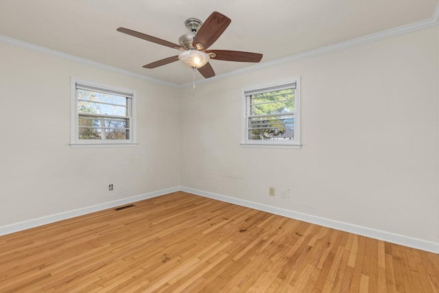 spare room featuring light hardwood / wood-style floors, ceiling fan, and crown molding