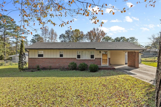 ranch-style home with a carport and a front yard