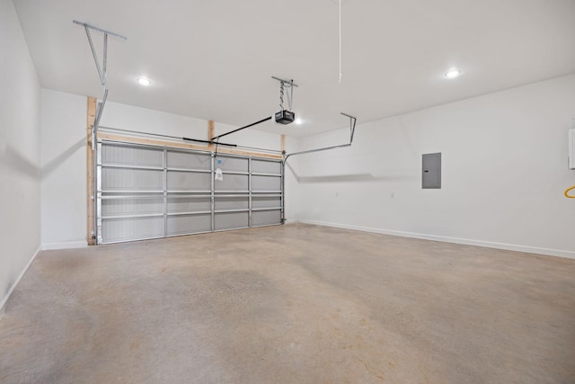 garage with a garage door opener and electric panel