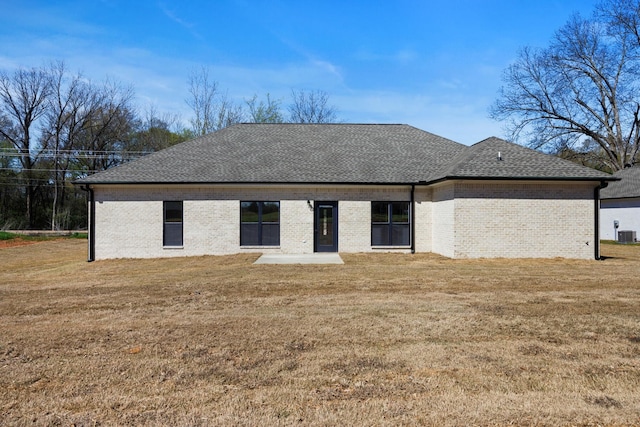 exterior space featuring a front yard and central AC unit