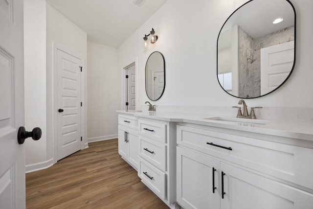 bathroom with hardwood / wood-style flooring and vanity