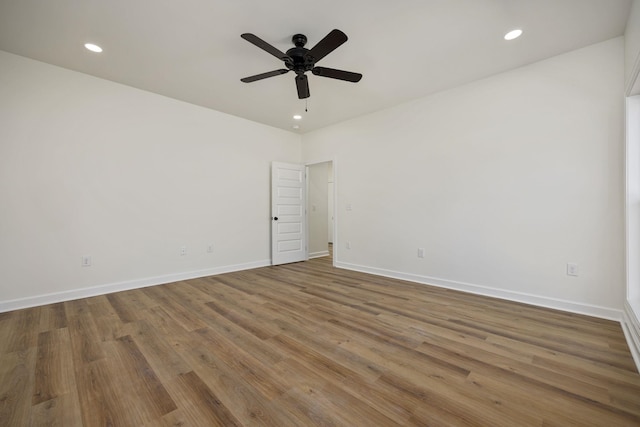 unfurnished room with ceiling fan and hardwood / wood-style flooring