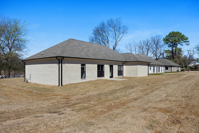 view of side of home with a lawn