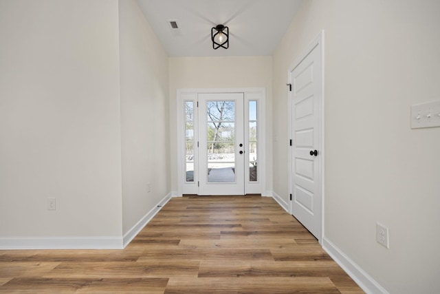 doorway to outside with light wood-type flooring