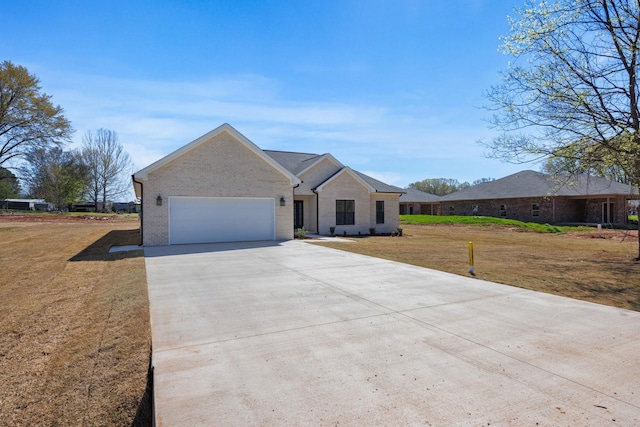 ranch-style house featuring a front yard and a garage