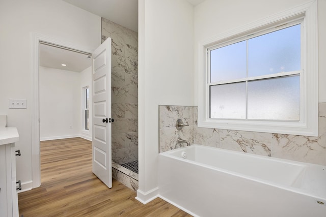 bathroom with wood-type flooring and separate shower and tub