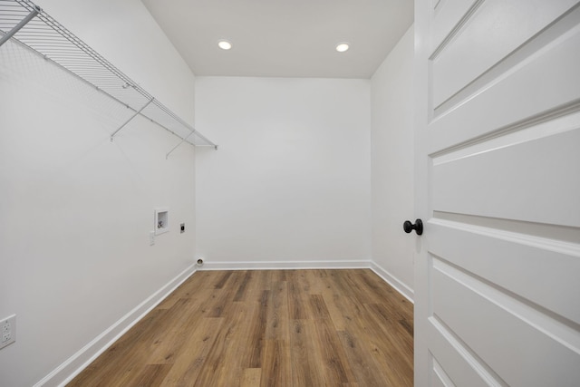 washroom with hardwood / wood-style floors, hookup for a washing machine, and hookup for an electric dryer