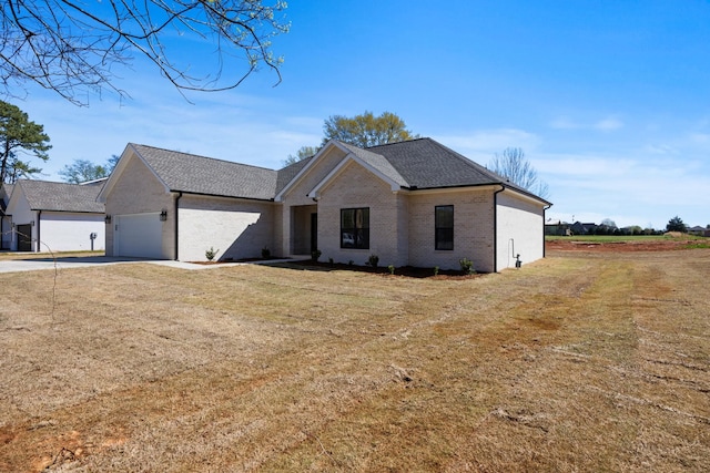 view of front of home with a front yard and a garage