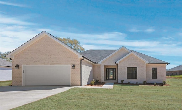 view of front of property featuring a garage and a front yard