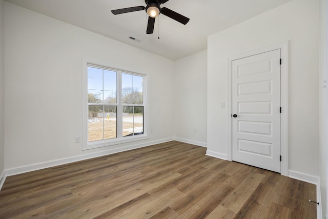 empty room featuring hardwood / wood-style flooring and ceiling fan