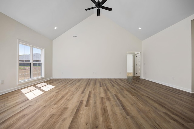 unfurnished living room with ceiling fan, hardwood / wood-style floors, and high vaulted ceiling