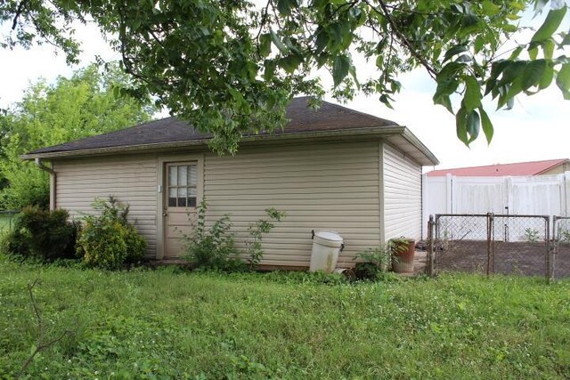 view of side of home with a yard