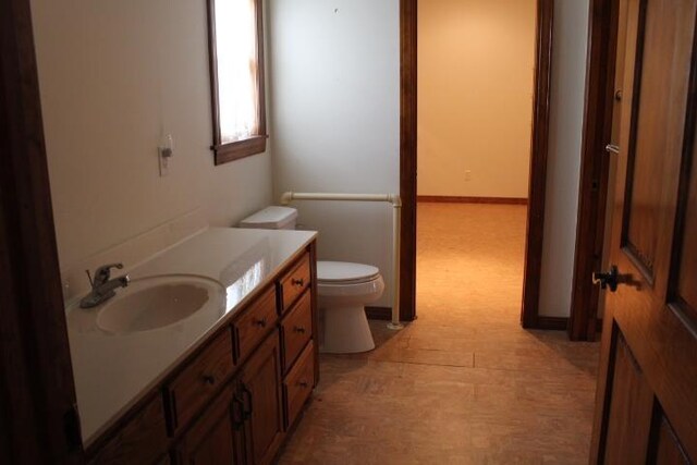 bathroom featuring vanity and toilet