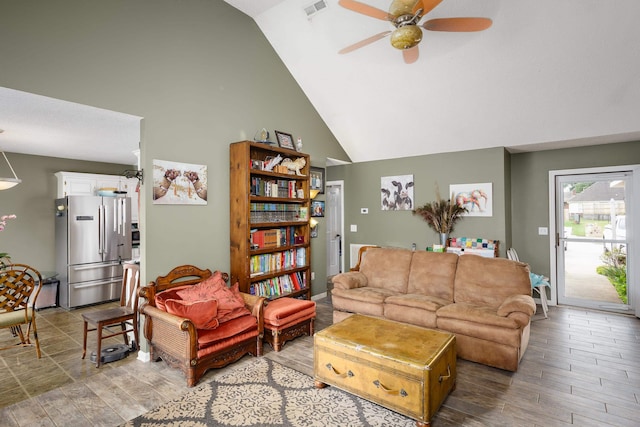 living room featuring ceiling fan and high vaulted ceiling