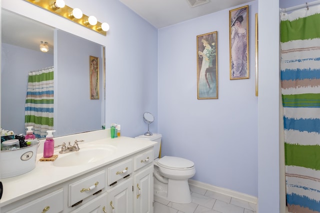 bathroom with tile patterned flooring, vanity, toilet, and walk in shower