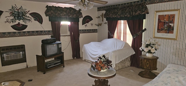 carpeted bedroom with wallpapered walls and heating unit