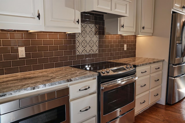 kitchen featuring stainless steel appliances, white cabinetry, tasteful backsplash, and stone countertops