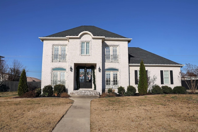 view of front of property featuring a front yard and french doors