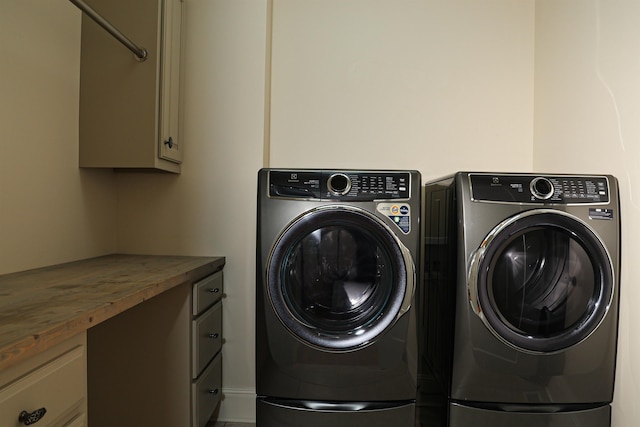 laundry area with cabinets and separate washer and dryer